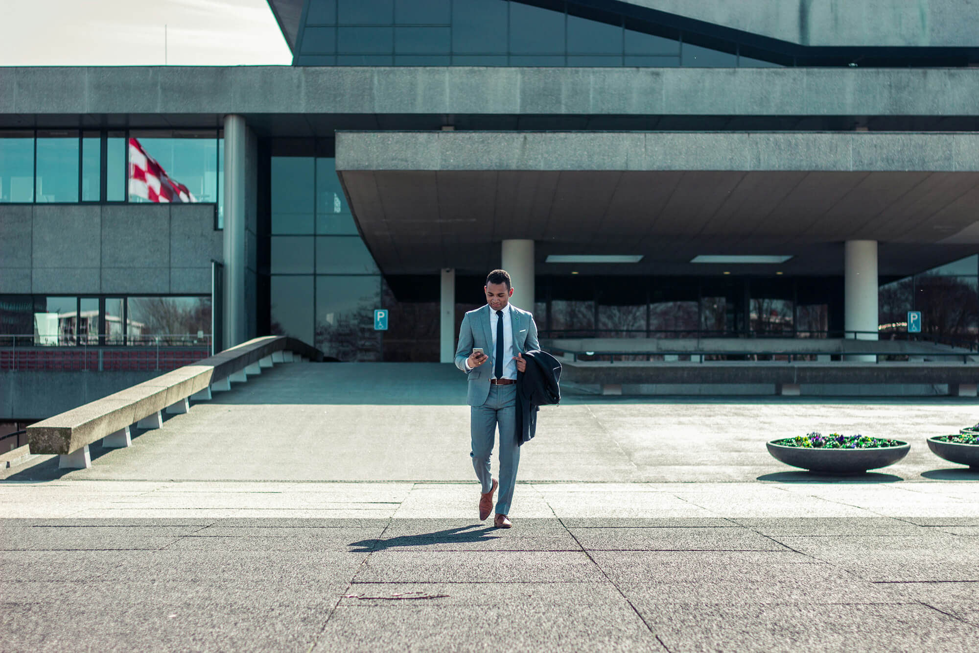 Man outside office building using his phone